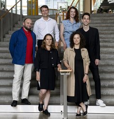 The six 2024-25 Fellows on a staircase before the symposium