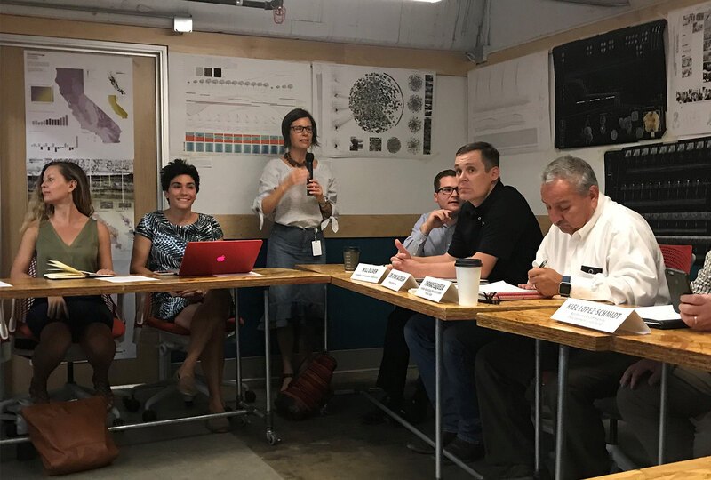Alison sits at a table with representatives from local advocacy organizations